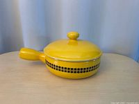 Full view of casserole with lid on showing color, shape, pattern, and handle