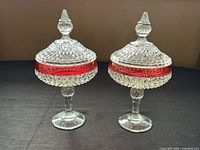 Front view of both covered compotes showing full shape and color band