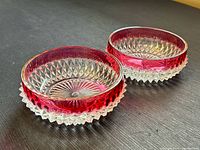 Both candy dishes angled view showing ruby band and starburst base