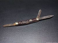 Knife open showing three blades