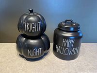 Both canisters front view showing text and lids