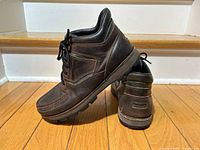 Side and rear views of both boots showing leather uppers and Vibram soles