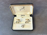 open presentation case with cufflinks and tie tack displayed