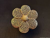 Front view showing six lattice petals and stippled center