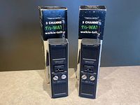 Pair of Realistic TRC-206 walkie-talkies standing in front of their boxes