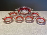 Full set arranged showing large bowl and six small bowls, ruby band visible
