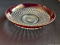Angled side view showing ruby rim and diamond pattern base