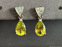 Front view of both earrings showing yellow teardrop crystals and AB rhinestone tops