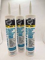 Front view of all three DAP Alex Plus caulk tubes showing labels and nozzles
