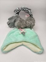 All three Justice items grouped: mint unicorn hat, grey gloves, grey faux-fur earmuffs