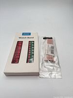 Box showing two Christmas-pattern bands for Apple Watch