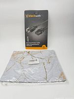 Front of packaged Blackweb power cable and sealed mouse pad