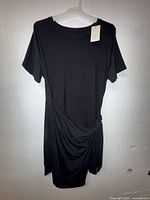 Full front view of black dress on hanger