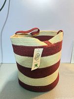 Full view of striped jute basket with tag attached