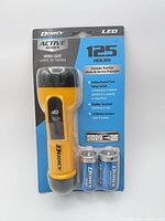 Front view of packaged Dorcy LED work light and included batteries