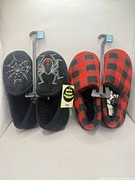 Both slipper pairs on hangers showing size tags and designs