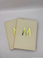 Front view of both cream monogram journals