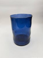 Front view of blue glass hurricane candle holder