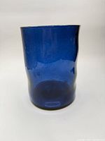 Front view of blue glass hurricane candle holder