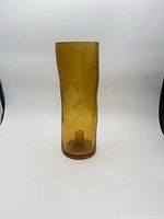 Front view of amber glass hurricane candle holder