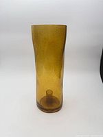 Full side view of amber glass hurricane candle holder