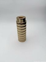 Side view of gold ribbed cylinder candle holder