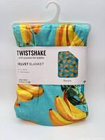 Front view of packaged Twistshake velvet blanket showing branding and banana print