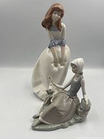 Front view of both porcelain figurines together