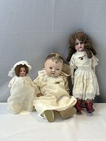 Front view of all three bisque dolls standing/sitting