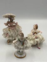 overview of three porcelain lace figurines