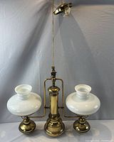 Full view of chandelier showing two milk glass shades and central column