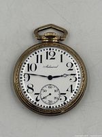 Front view of pocket watch showing dial and hands