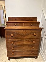 Front view of wooden dresser, drawers closed