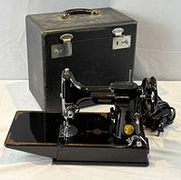 Singer 221 machine on table with case and foot pedal