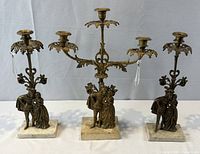Front view of complete girandole set showing three pieces, arms, figures, marble bases