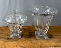 Jar and vase side by side on wood surface