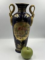 Full view of cobalt blue porcelain vase with twin gilt handles