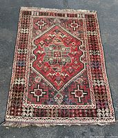 Full view of rug showing design, borders and fringe