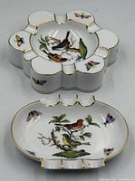 Top view of both ashtrays showing shape, decoration, gilt trim