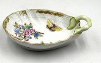 Top angled view showing leaf shape, handle, floral and butterfly motifs
