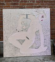 Full view of square textured nude painting against brick wall