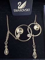 Necklace in box showing crystals, tag, chain