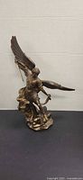 Front view of bronze-tone Archangel Michael statue with sword and wings