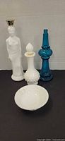 Group shot of four Avon glass items