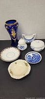 Group shot of cobalt vase, three blue-and-white pieces, floral jar, two plates and bowl