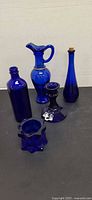 Group view of five cobalt blue glass pieces