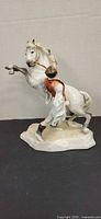 Front view of Herend Csikos figurine showing rearing horse and trainer