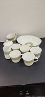 Group shot of all Noritake pieces including mugs, creamer, sugar bowl, casserole dish