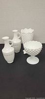 Group view of four milk glass items