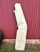 Full view of rudder front side leaning against corrugated wall